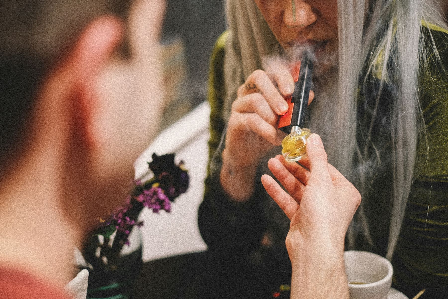 girl taking a dab of cannabis concentrate